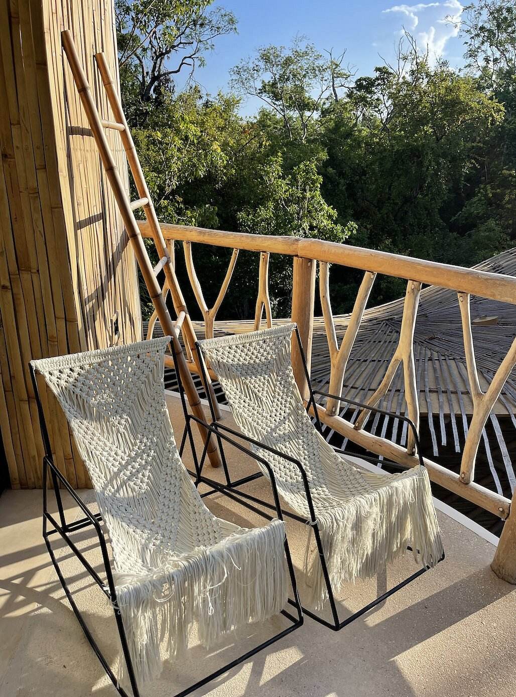 Macramé chairs on a treetop balcony
