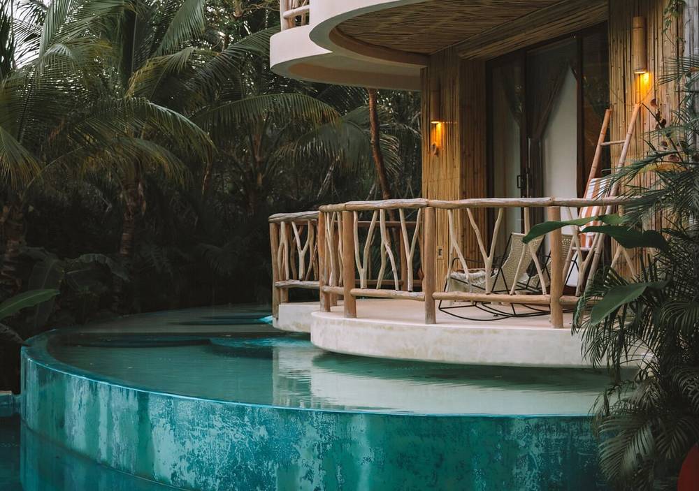 Winding jungle pool beneath curved balconies